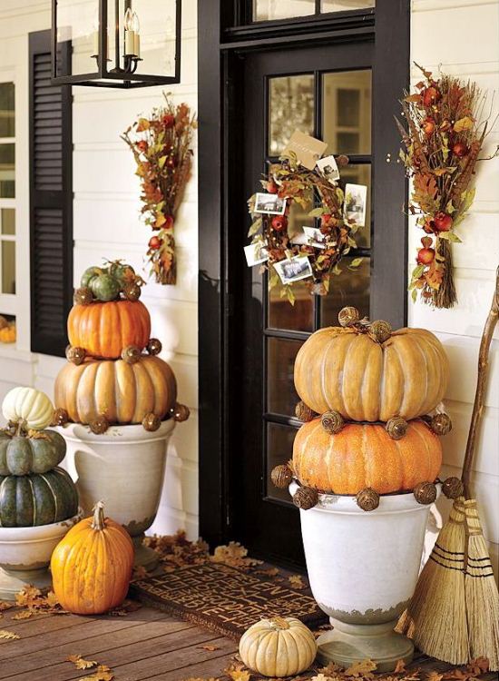 Giant pumpkins in footed urns. (Photo: Pottery Barn)