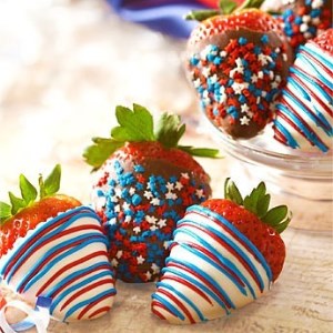 Strawberries, dipped in chocolate and coated in patriotic color.
