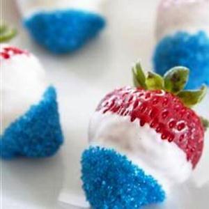 Strawberries in white chocolate and blue sparkles. (Photo: All Recipes)
