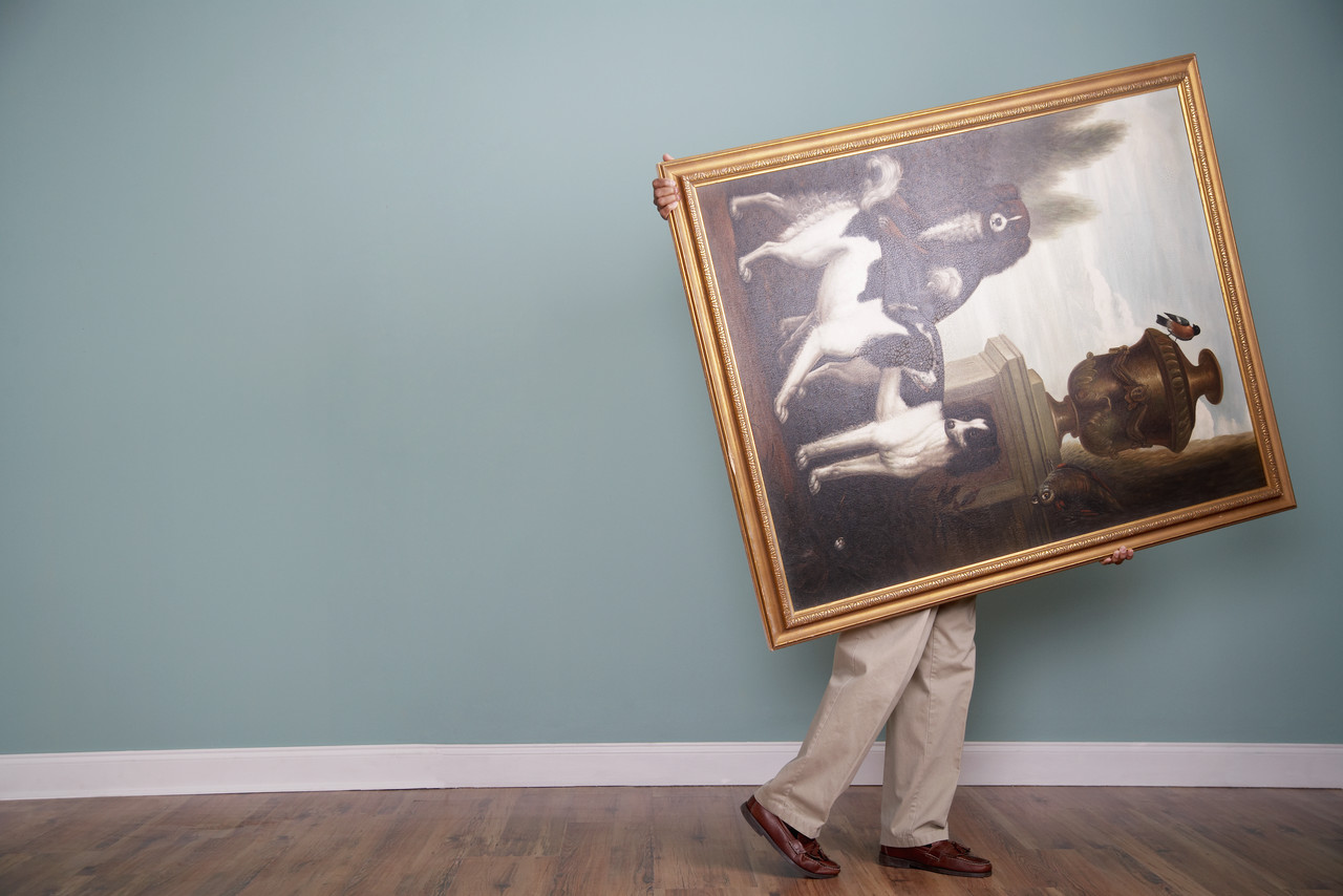 Man moving a painting