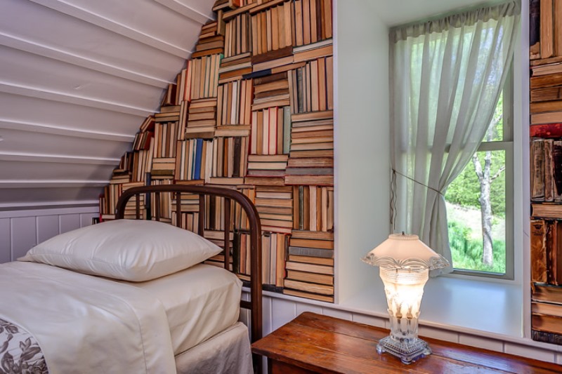 Real books fill a wall in the loft bedroom.