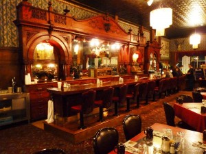 Irma Hotel's original cherry wood bar is ornate, exquisitely carved, and made from a single piece of wood. (Photo: Andrew Varga)
