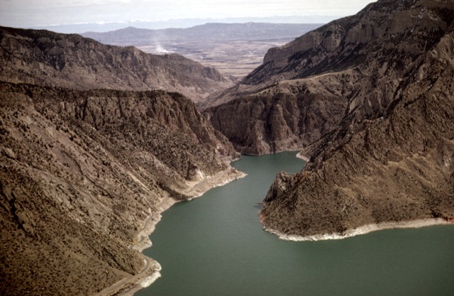 Aerial view - At Buffalo Bill Reservoir, looking east towards Cody, the highway follows the reservoir's shoreline right into the mountain where the tunnels are. (Photo: Louis J. Maher, Jr.)