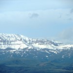 Closeup of the distant, snow-capped Absaroka Range on a clear day in mid-May.